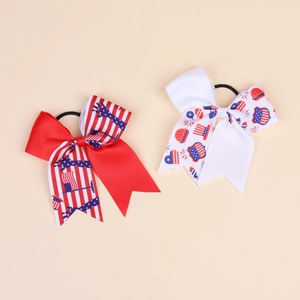 Detail showing two Independence Day hair bows with red white and blue patriotic patterns