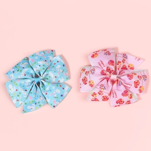 Detail view of Easter hair bows featuring rabbit prints and Happy Easter egg patterns