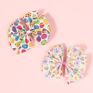 Detail of Easter hair bows with colorful egg and bunny prints on grosgrain ribbons