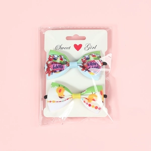 Close-up of Easter hair accessories with Happy Easter prints on a pink background