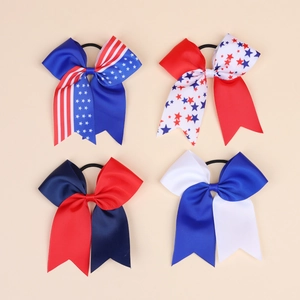 Close-up of four USA Independence Day bow hair ties with stars and stripes patterns
