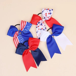 Detail of four American flag themed bow hair ties with ribbed texture and elastic bands