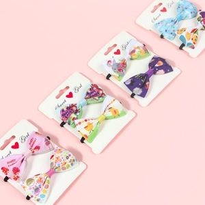 Detailed close-up of Easter-themed ribbon bow hair ties with cute bunny and egg patterns