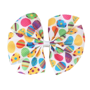 Kids large Easter hair bow with colorful egg patterns on white ribbed polyester ribbon