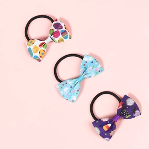 Detailed close-up of colorful Easter bow hair ties with cute bunny and egg patterns