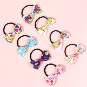 Set of eight colorful Easter bow hair ties with bunny and egg prints on pink background
