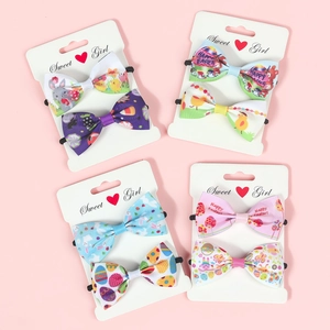 Close-up of Easter hair bows with rabbit and egg prints on display cards for girls