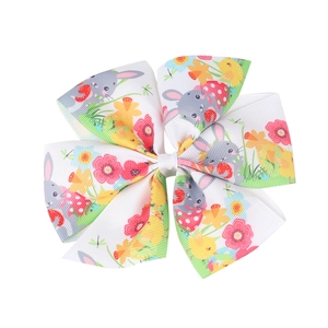 Detail of Easter hair bow with rabbit and chick patterns on grosgrain ribbon