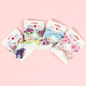 Detailed view of Easter ribbon bow hair clips with cute rabbit and egg patterns for kids