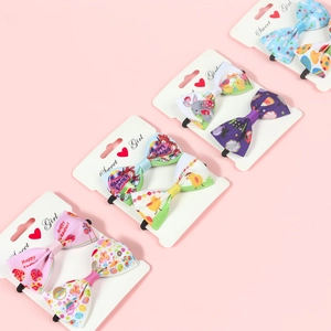 Detail view of Easter hair bows with bunny and egg patterns on macaron ribbons