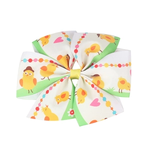 Detail of Easter hair bow with cute yellow chick patterns on ribbed grosgrain ribbon