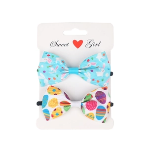Two-pack Easter hair ties with bunny and colorful egg patterns on ribbon bows