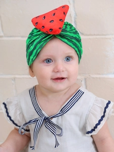 Detail of baby watermelon turban with red felt slice and green striped fabric pattern