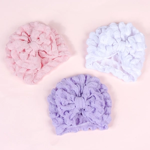 Baby turban hat set with large bow in pink, white, and purple textured waffle fabric