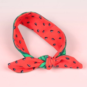 Close-up of watermelon pattern knot headband with vibrant red and green colors
