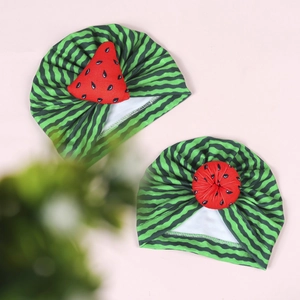 Detailed view of elastic infant turban hats with green watermelon stripe patterns
