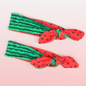 Pair of elastic baby headbands with vibrant watermelon bow design and wavy patterns