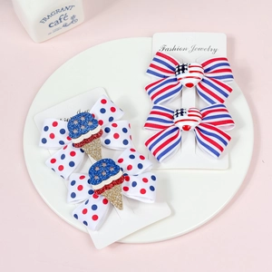 Detail of red white and blue American flag hair clips with polka dots and stripes on card