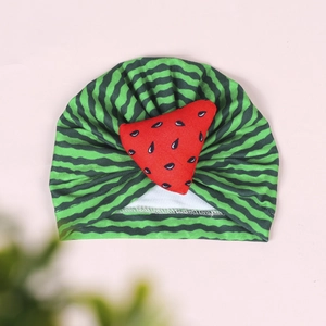 Detailed close-up of a baby turban hat with green stripes and red watermelon motif