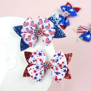 Detailed view of Fourth of July glitter hair bows with American flag star patterns