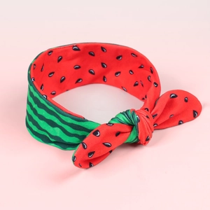 Close-up of elastic baby headband with watermelon skin patterns and red fruit inner lining