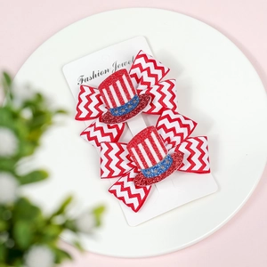 Detail of US Independence Day themed bow hair clips with glitter top hat decor