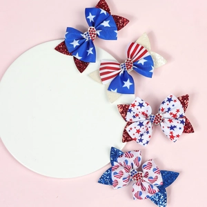Detail of red white and blue bow clips with sequins and star patterns for Independence Day