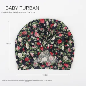 Macro detail of navy blue floral baby turban with central bow and high elasticity fabric