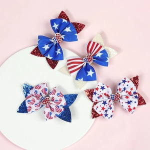 Close-up of patriotic American flag bow clips with glitter sequins and rhinestone hearts