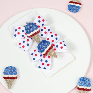 Detail of glitter ice cream bows on display card with red and blue polka dots