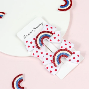 Detail of red star printed hair bows for kids with sparkling rainbow center on card