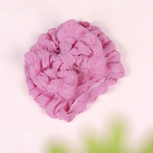 Close-up of pink seersucker baby turban hat featuring a decorative knotted bow detail