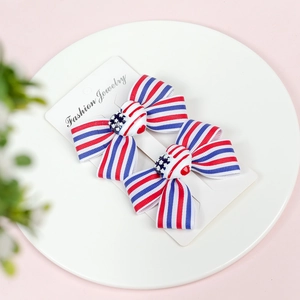 Pair of US Independence Day bow hair clips with stripes and stars on card