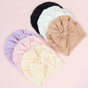 Close-up of soft ribbed texture and large bow detail on colorful newborn baby turbans