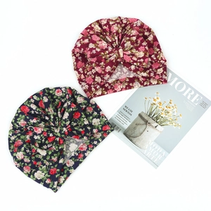 Detailed view of floral pattern baby turban hats with large decorative front knots