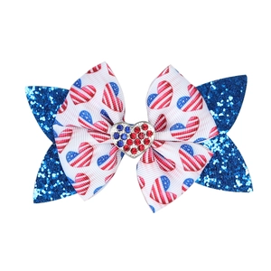Detail of glitter sequin bow hair clip with American flag heart pattern and rhinestones