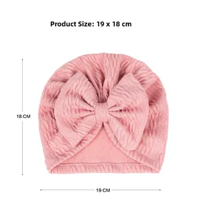 Pink newborn turban hat with bow detail and 19 x 18 cm size measurement reference