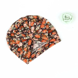Detail of floral print turban hat for children featuring a large soft knot bow decoration