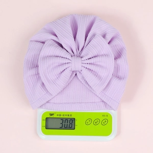 Light purple newborn beanie weighing 30.8 grams showing high elasticity and soft texture