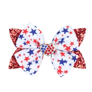 Detail of USA patriotic hair bow with stars, glitter tail, and heart rhinestone center