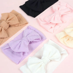 Detail view of 6-color elastic ribbed knit baby headbands with large bows for newborns
