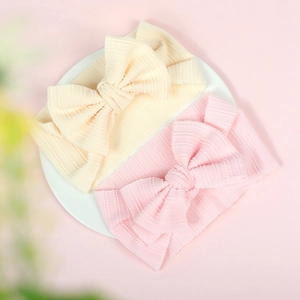 Close-up of soft ribbed texture and large bow details on baby elastic headbands