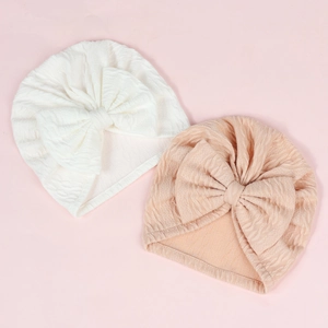 Detailed texture of baby turban caps with large bow and wave pattern knit fabric