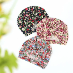Three-pack of soft floral infant beanies featuring decorative front knots in various colors