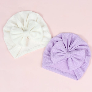 Elastic baby turban hats with large bow detail in lavender and cream jacquard fabric