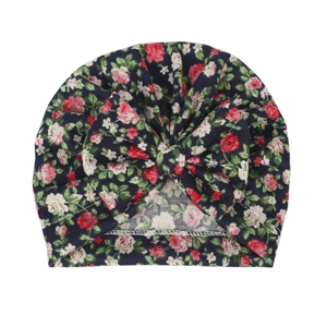 Floral navy blue baby turban hat with a large bow detail made of soft knitted cotton fabric