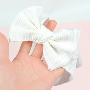Soft white ribbed knit baby headband with a decorative bow knot for infants