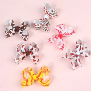 Detail of 3-inch ribbed ribbon hair bows featuring vibrant baseball and football sports prints