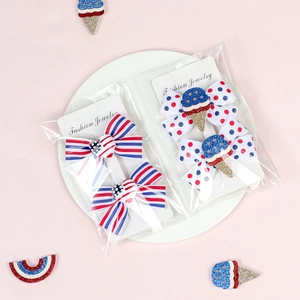 Detail of USA Flag inspired hair clips with polka dots and stripes on a display card