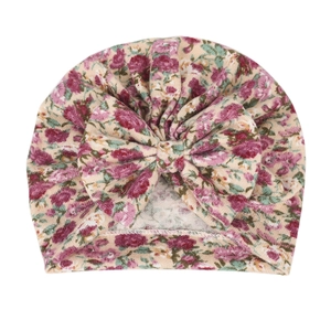 Detail of baby floral turban hat with large bow made of soft stretch knit fabric